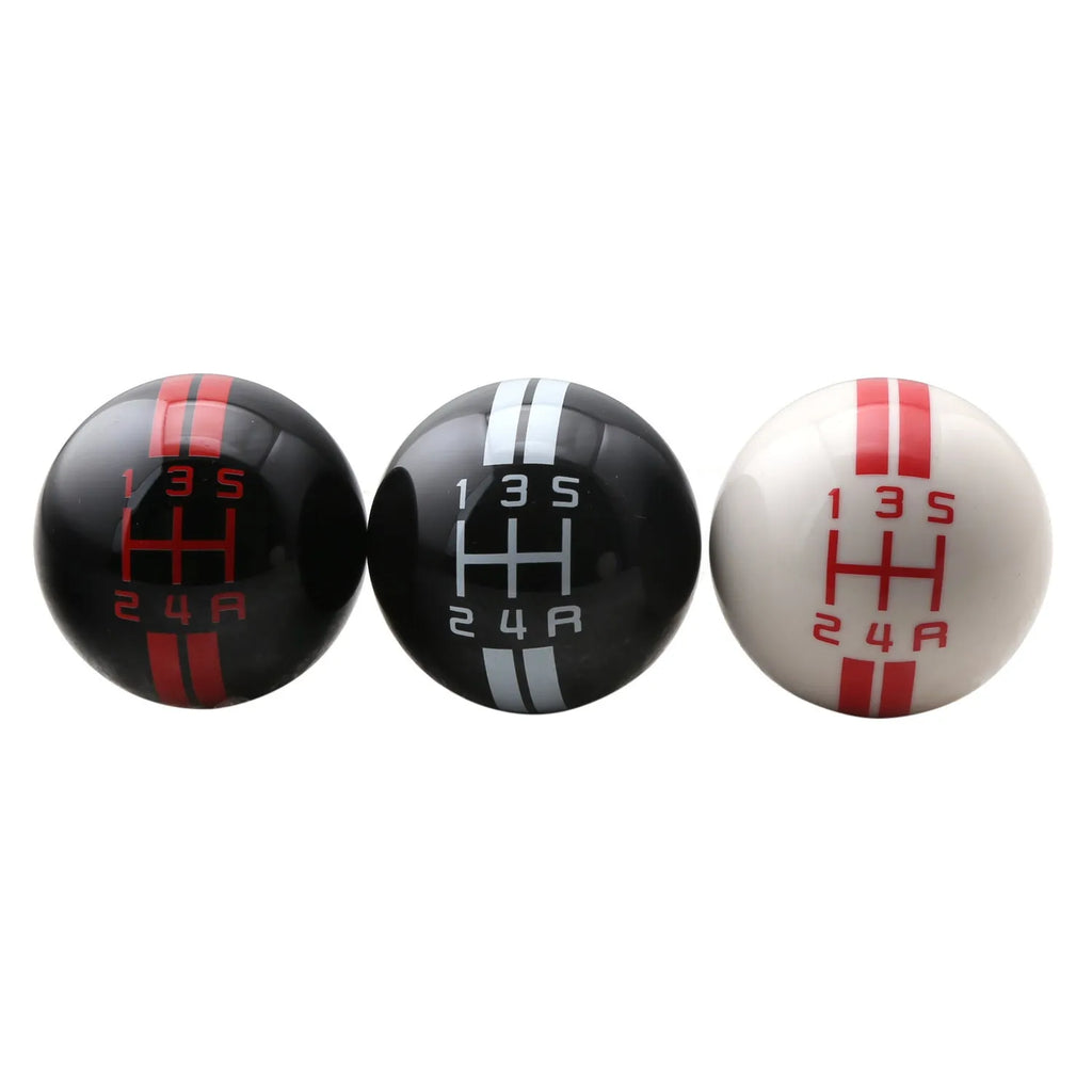 Black acrylic car gear head for 5-speed manual transmission, showing red lettering shift pattern.