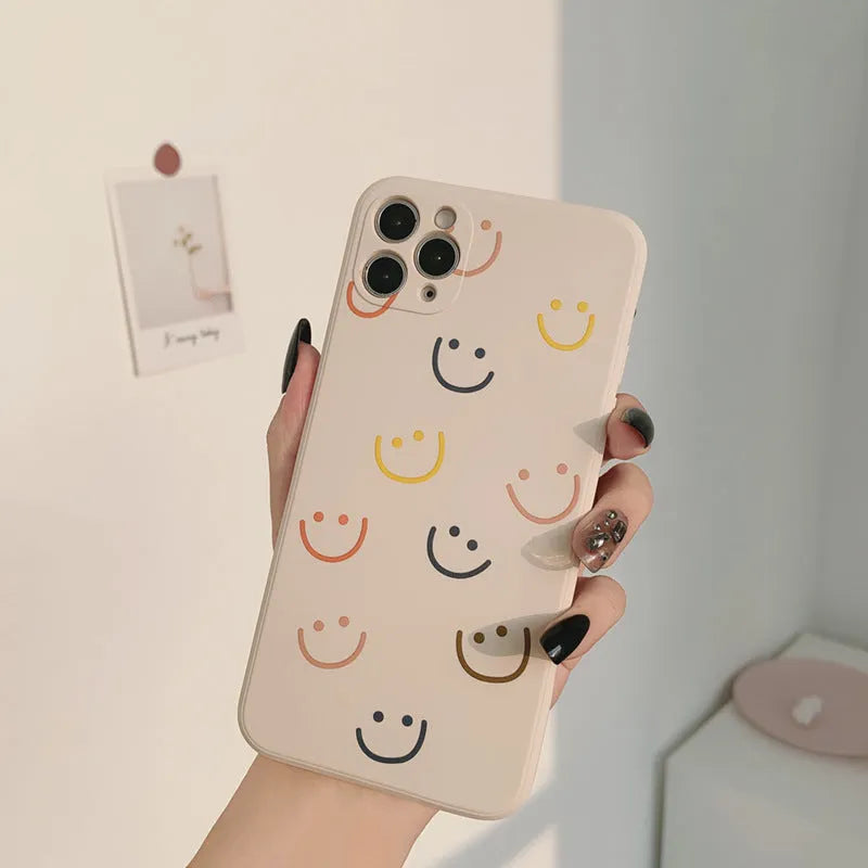 Simple silicone iPhone case with smiley face design in multiple colour options