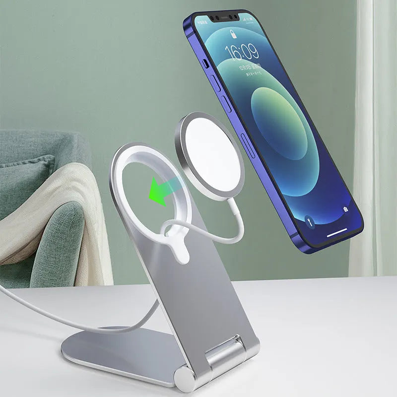 Silver vertical adjustable magnetic phone bracket for iPhone 12 on a car dashboard.