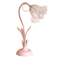 Pink princess room desk lamp with ceramic flowers, glass lampshade, and dimmer switch on a wooden desk