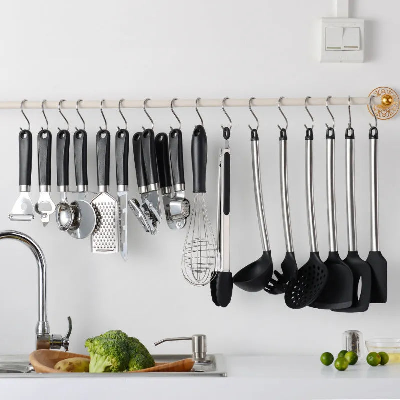 Black silicone kitchen utensil set with stainless steel handles including spatulas and spoons