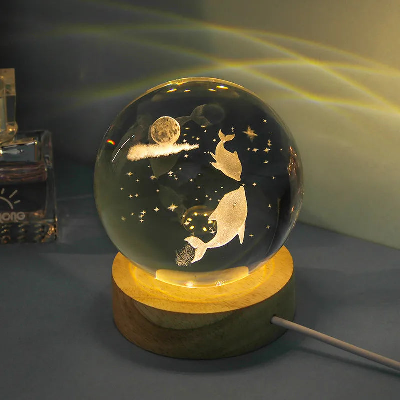 Transparent crystal ball night lamp with 3D carved jellyfish design, on a round base with USB cable.