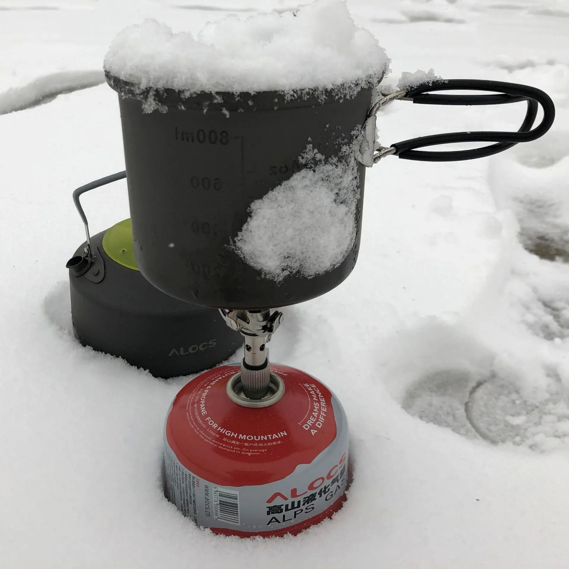 Portable folding mini camping stove in unfolded position showing 3000W burner and anti-skid bracket