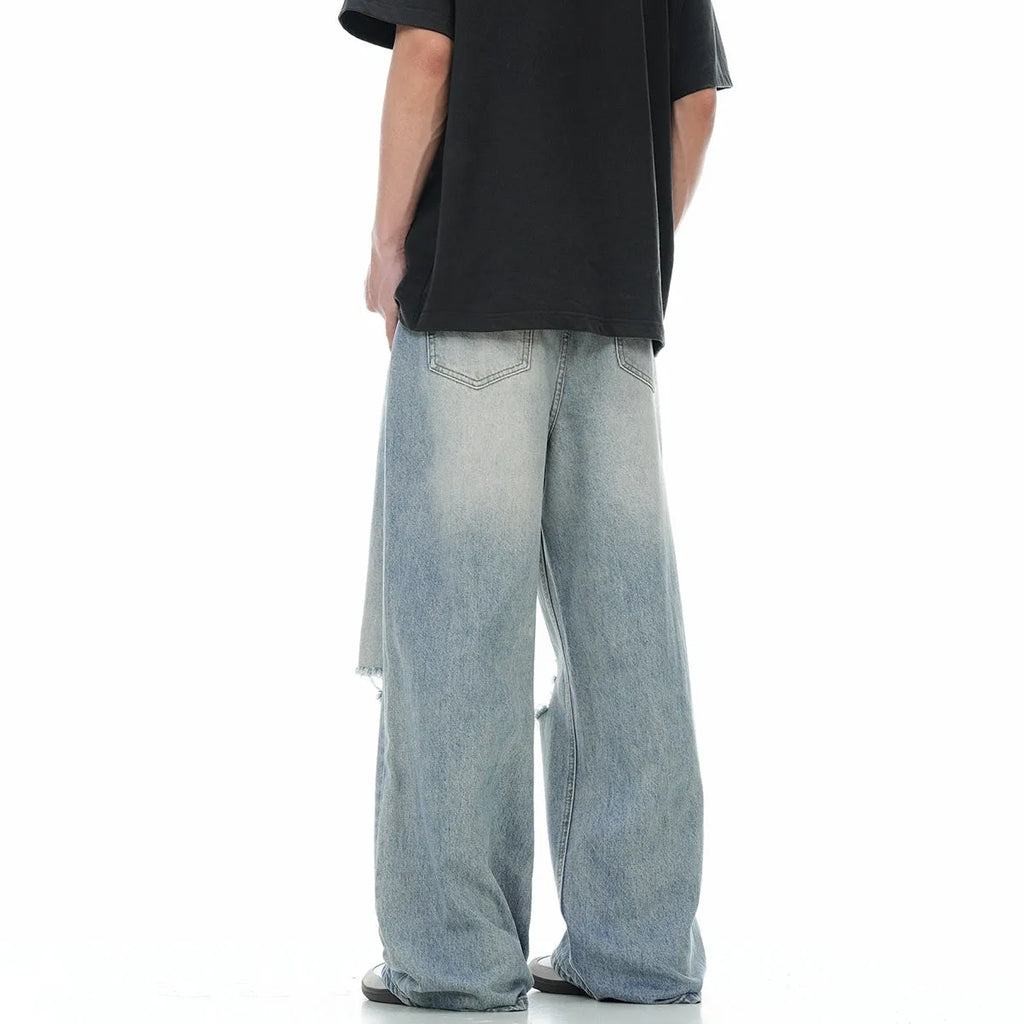 Blue retro straight-leg jeans with ripped details on a mannequin.