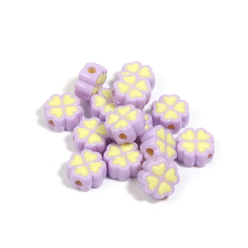 Assortment of frosted light green, pink, and yellow acrylic four-leaf clover craft beads, 15mm in size.