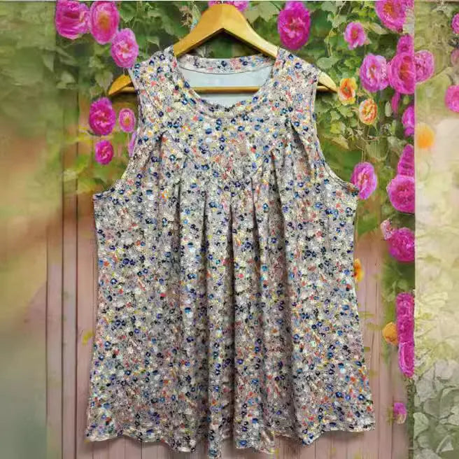 Plus-size black floral print sleeveless vest with round neck on a hanger, showing loose fit.