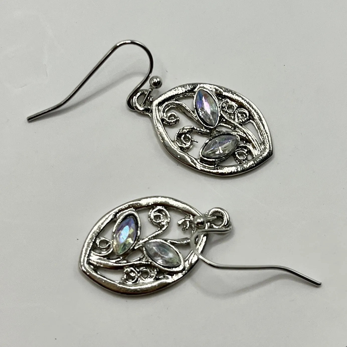 Silver colour alloy earrings with a leaf design and embedded colourful moonstones for women.