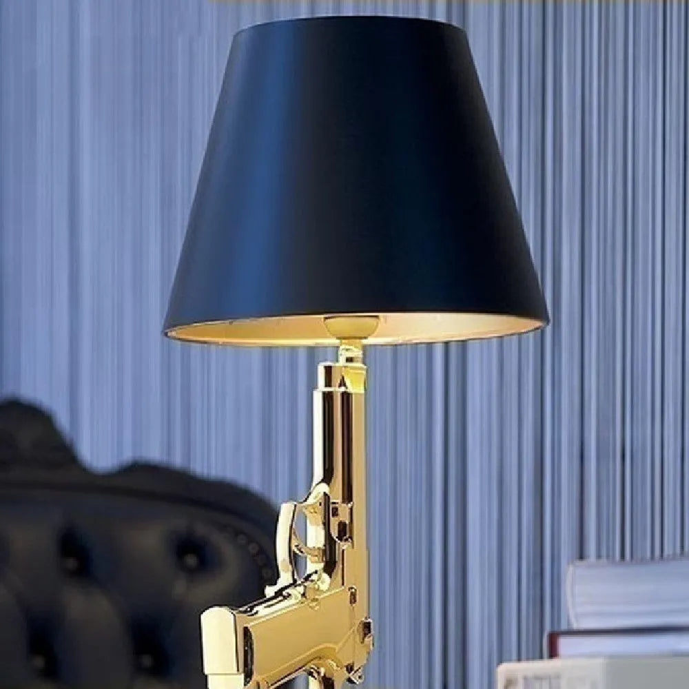 Creative resin desk lamp with plated gold pistol shape on a desk, 235x425mm, Nordic style