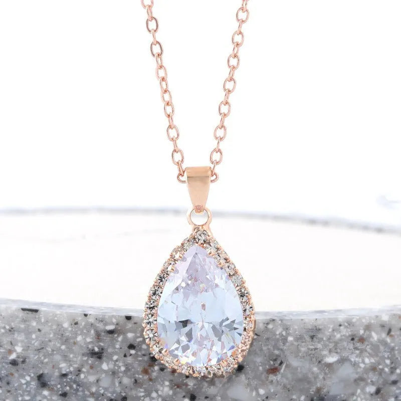 Women's water drop shaped pink necklace with rose gold rhinestone geometric detailing on alloy chain