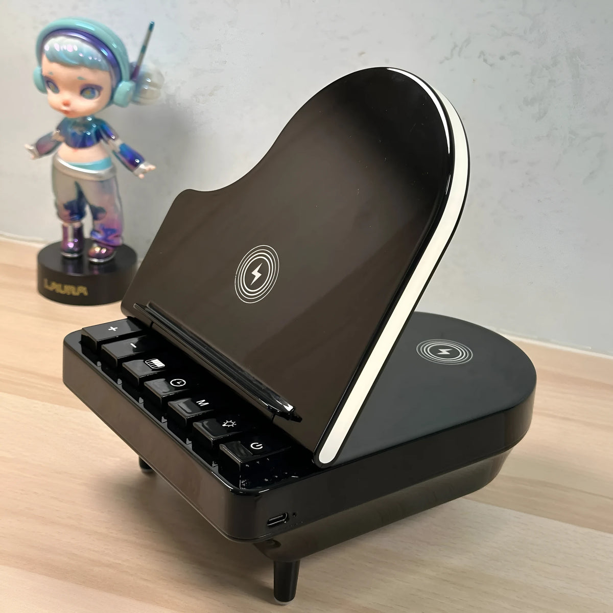 Black multi-function Bluetooth speaker with wireless charger and phone holder showing LED lighting
