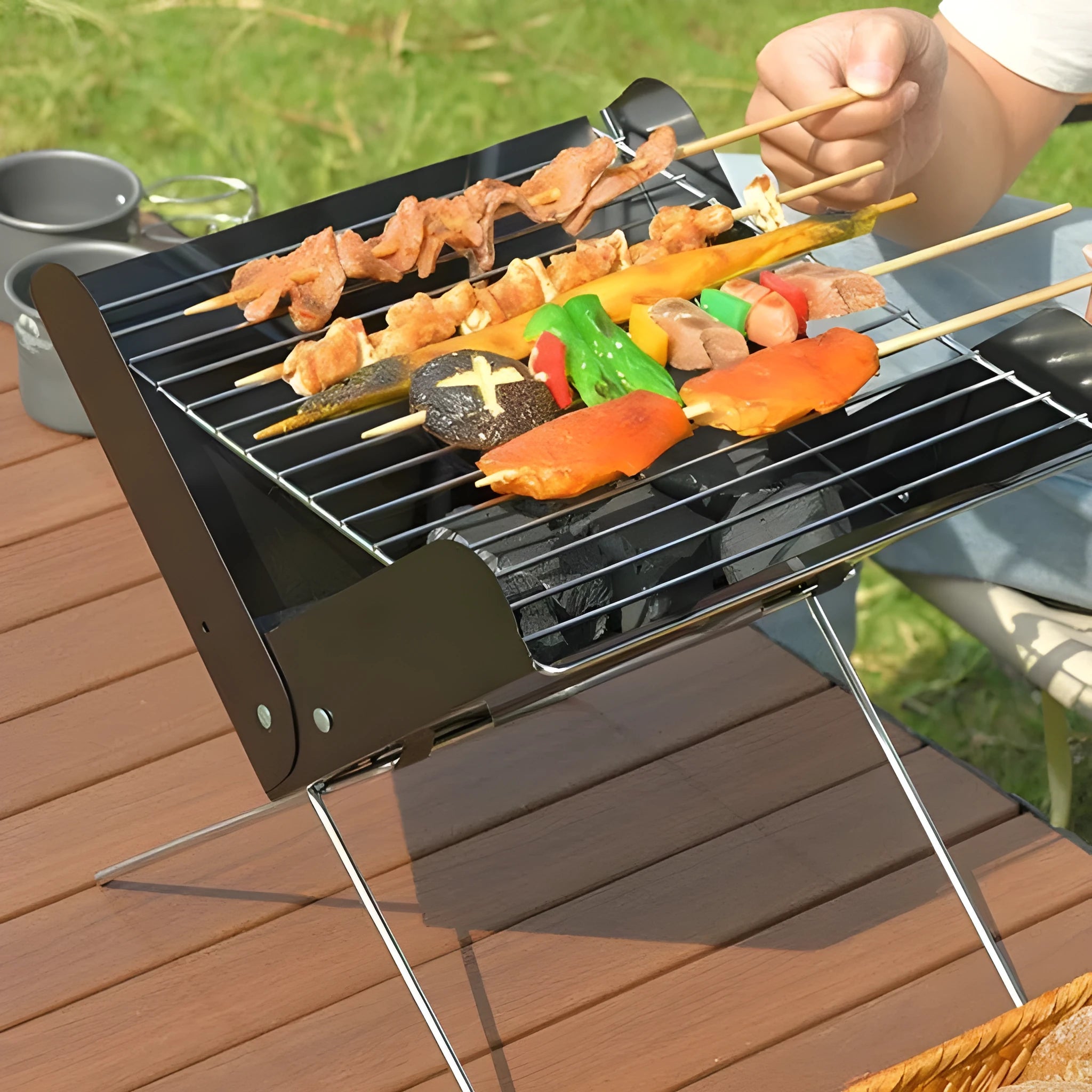 Portable black metal barbecue grill measuring 29x26x29cm for outdoor camping and picnic use