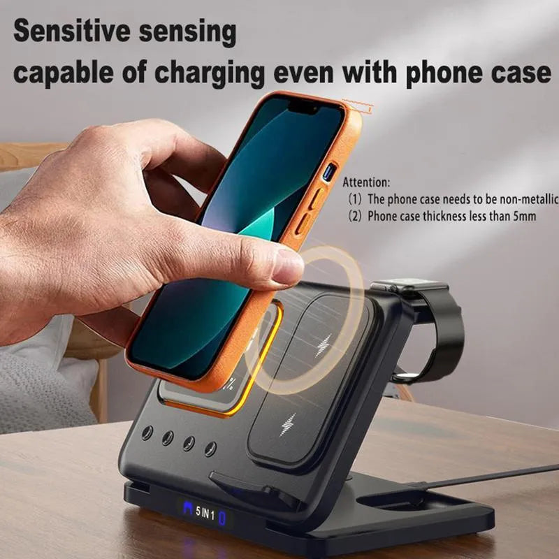 Black and white wireless charging dock station with digital clock display charging a phone, watch and headphones
