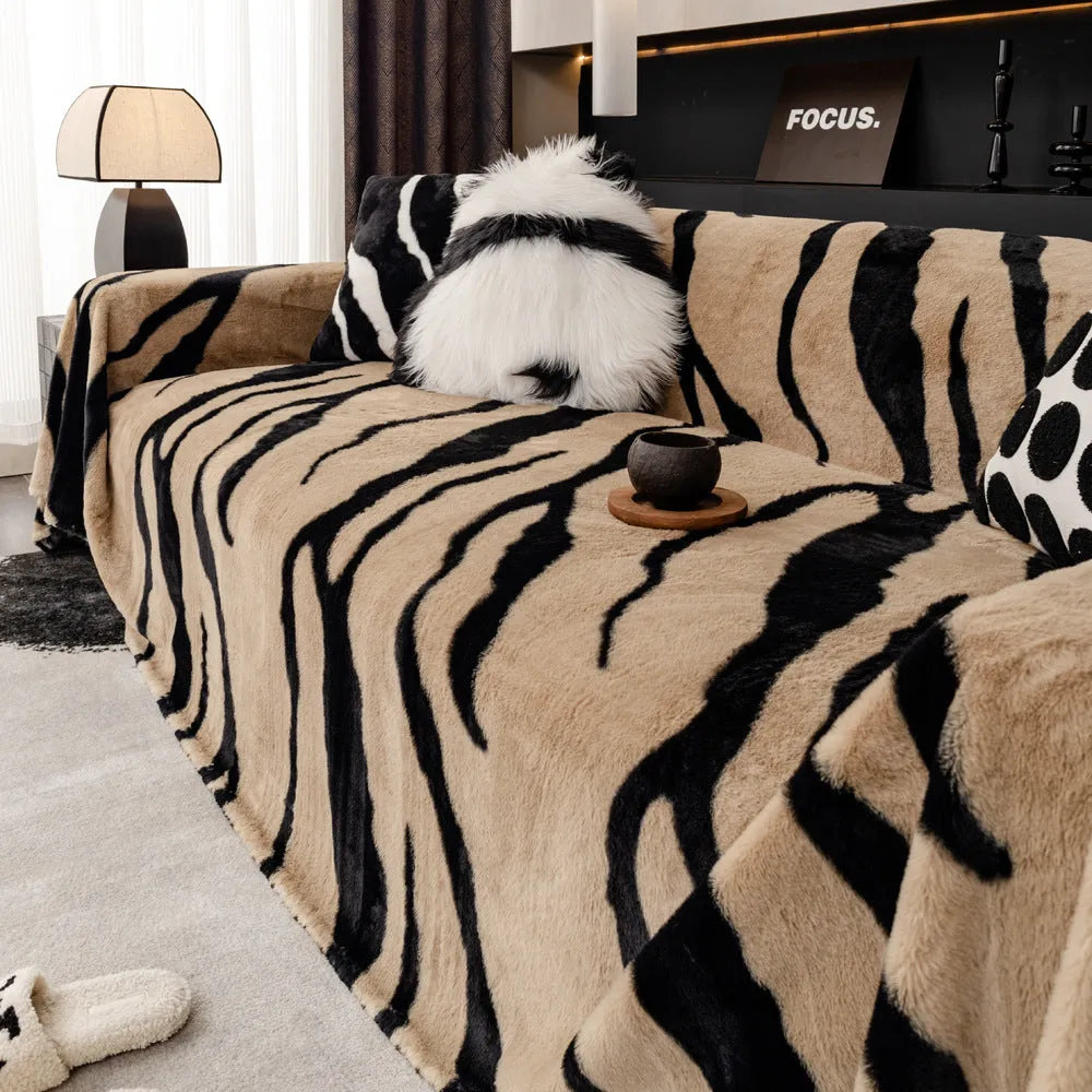 Zebra pattern flannel sofa cover in caramel colour on grey sofa, showing thickened non-slip construction.