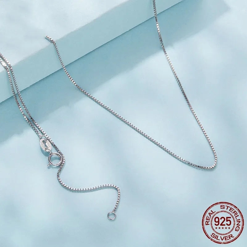 S925 sterling silver box chain necklace in silver colour, 40cm length on flat surface