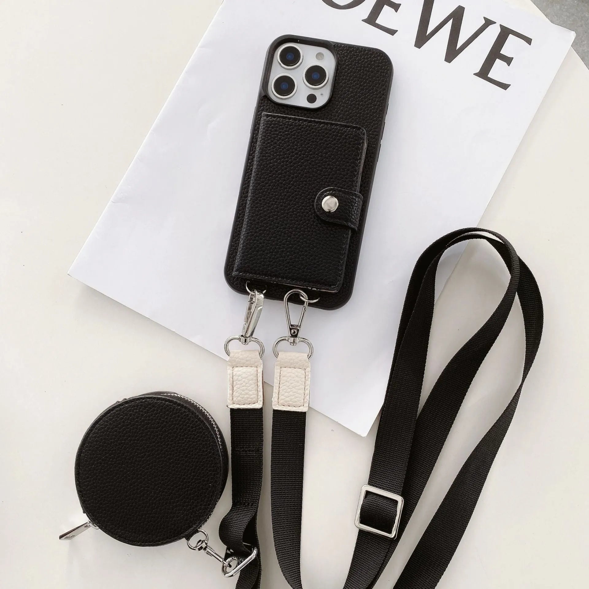 Black PC leather phone case with card slot and attached lanyard for iPhone, shown alongside credit cards.