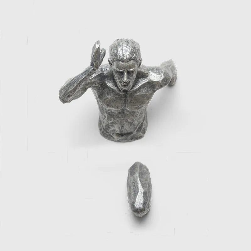 Resin character wall hanging decoration in metallic finish on a plain wall