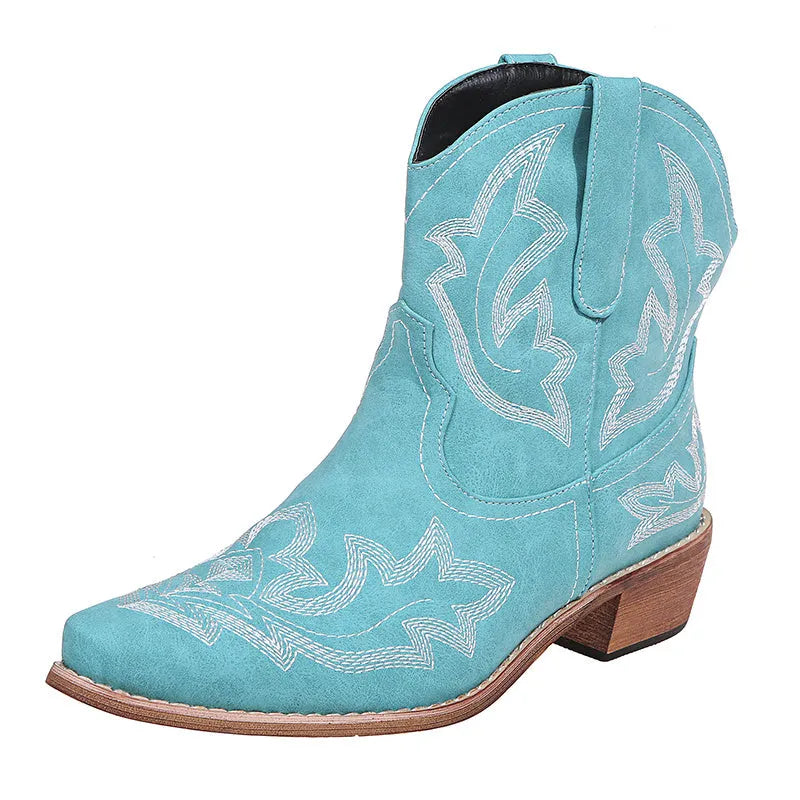 Women's blue embroidered cowboy boots with a wedge heel and pointed toe on a white background.