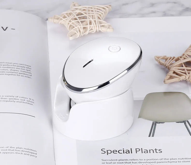 White multifunction USB charging facial cleansing massager with hot egg design, silicone brush head, and 5 vibration modes on a white background
