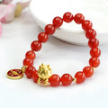 Close-up of a red agate bead dragon zodiac bracelet on a wrist, showing 8mm beads.