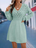 Women's long sleeve apricot V-neck dress with high waist and 3D pattern detail.