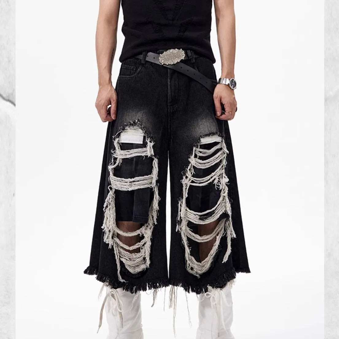 Black cropped wide-leg jeans with ripped patch details and mid-high waist