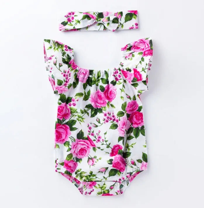 White baby girl's sleeveless cotton romper with small flying sleeves on a hanger.