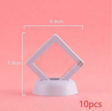 3D floating display case holding a coin suspended between transparent membrane sheets, black frame