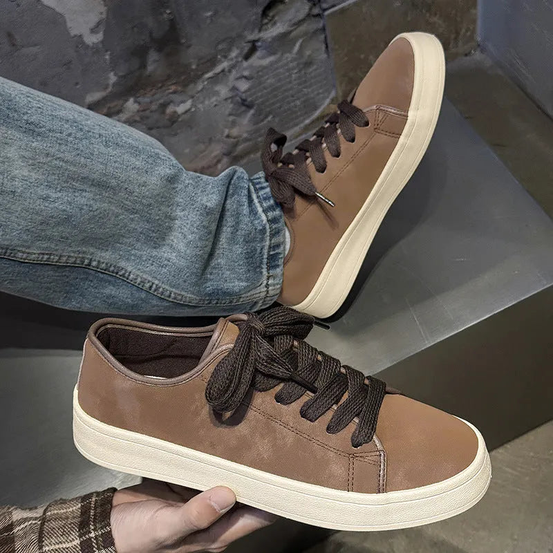 Breathable matte leather sports casual shoes in black with stitched detailing, low-top profile, and rubber sole