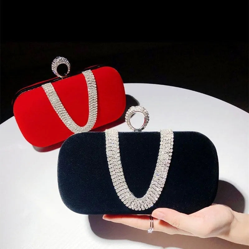 Small velvet evening clutch bag with rhinestones and lock closure, horizontal square shape, available in multiple colours.