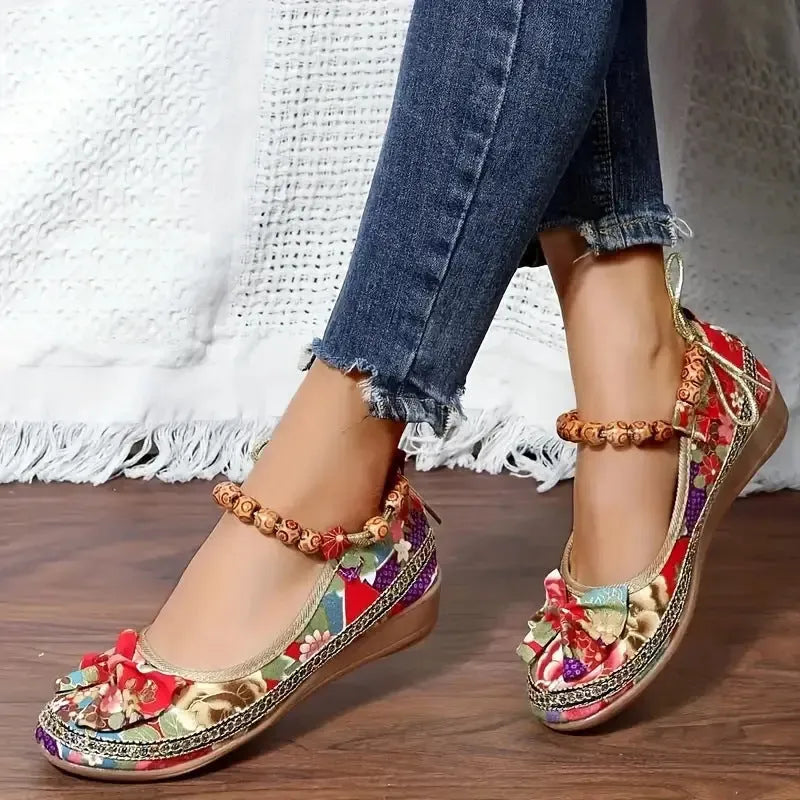 Women's black ethnic style platform sandals with elastic band and round toe on a cloth upper.
