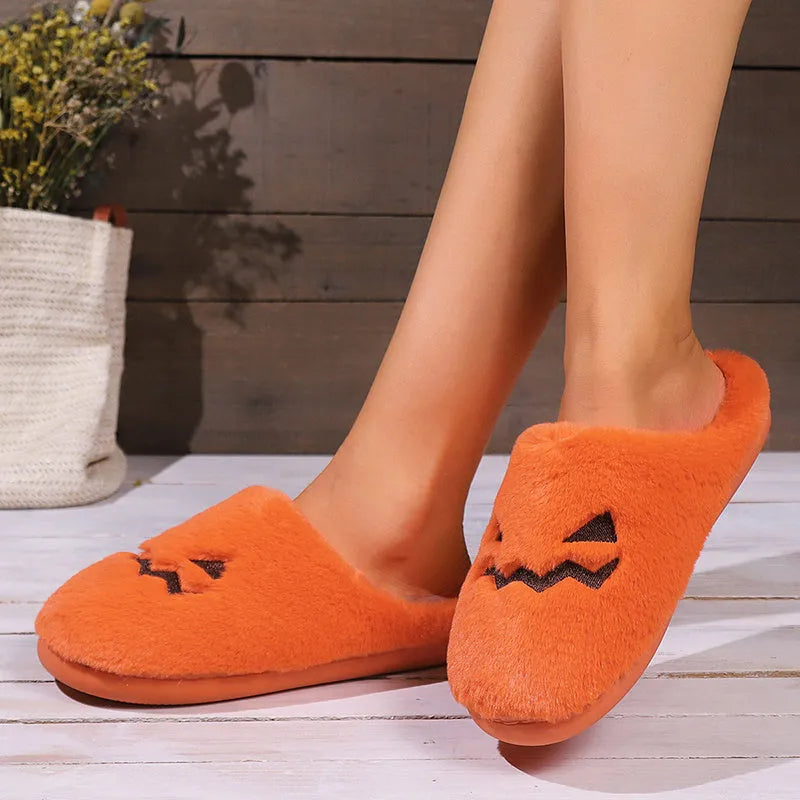 Orange pumpkin-shaped plush slippers with coral velvet upper on a non-slip PVC sole