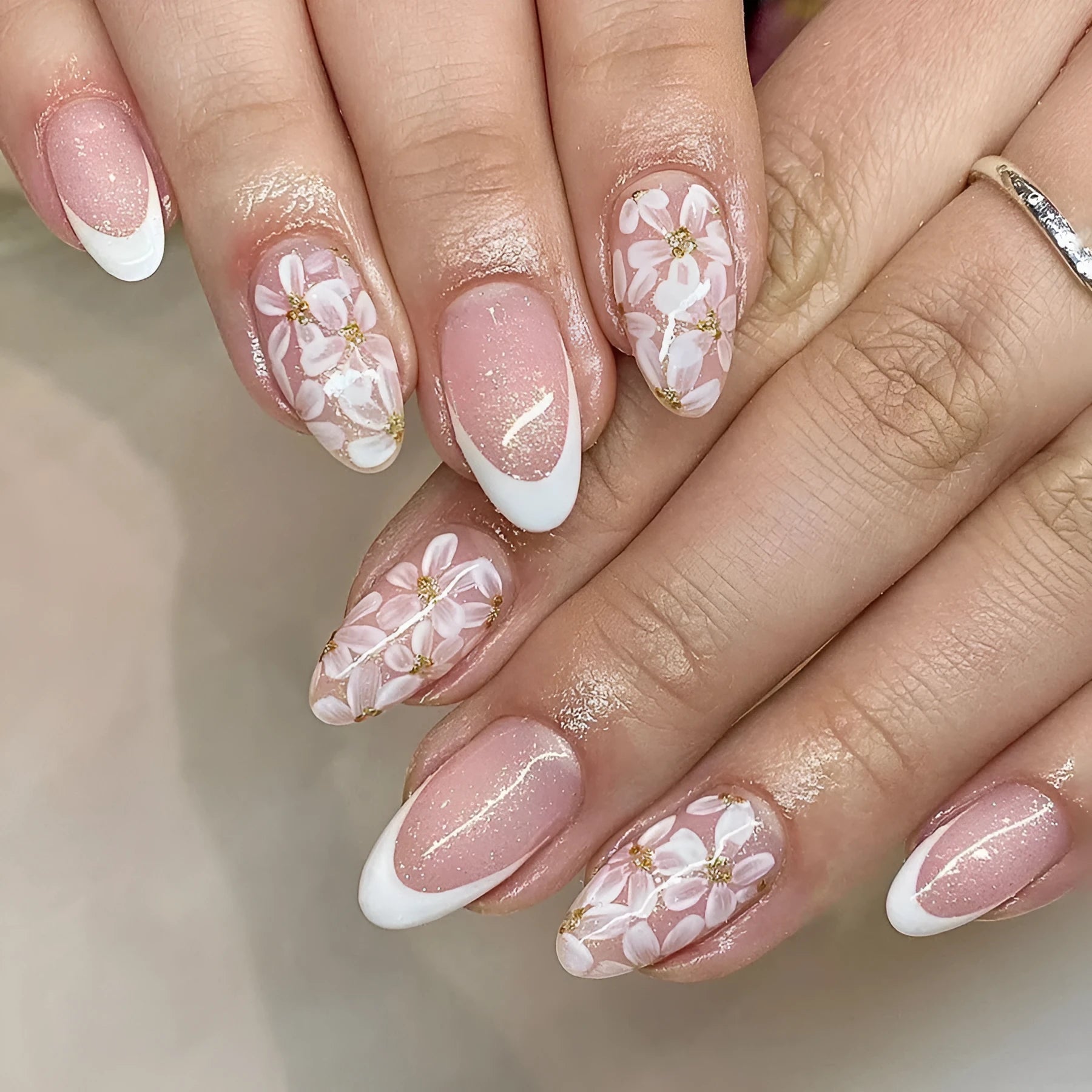 Short almond French manicure artificial nails with glitter and flower patterns in colour C625.