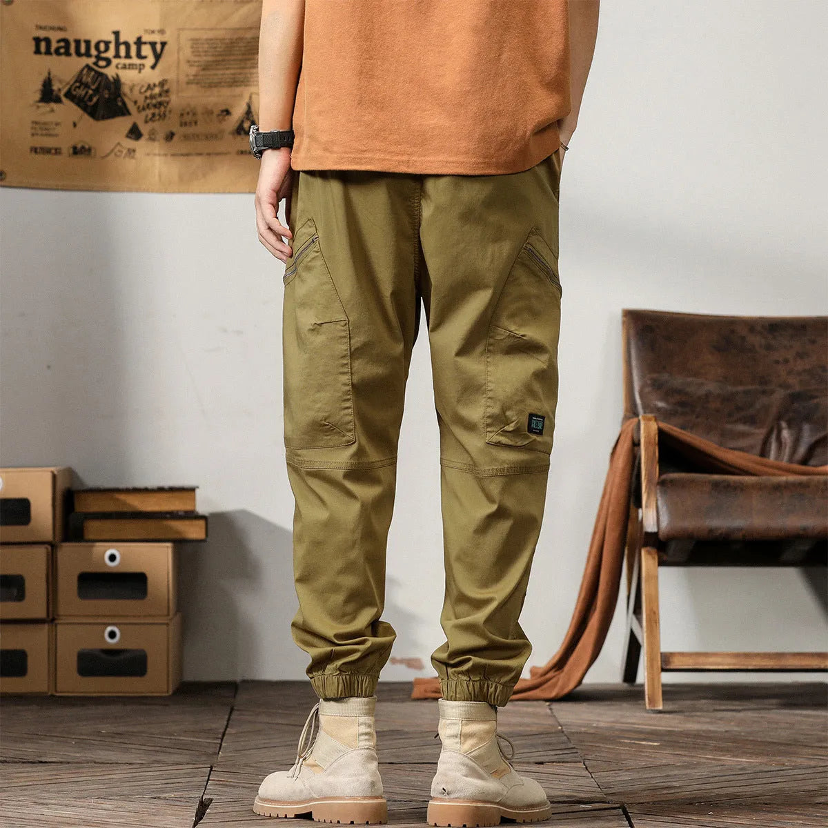 Men's khaki cotton harem pants with ankle bands and a loose, tapered fit.