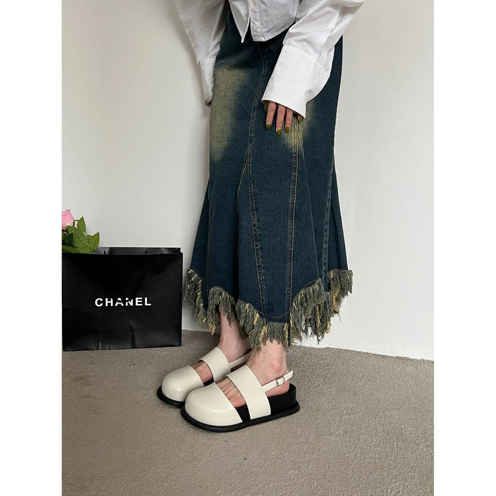 Korean style women's retro sandals with a black microfiber upper and adjustable ankle buckle on a PVC sole.
