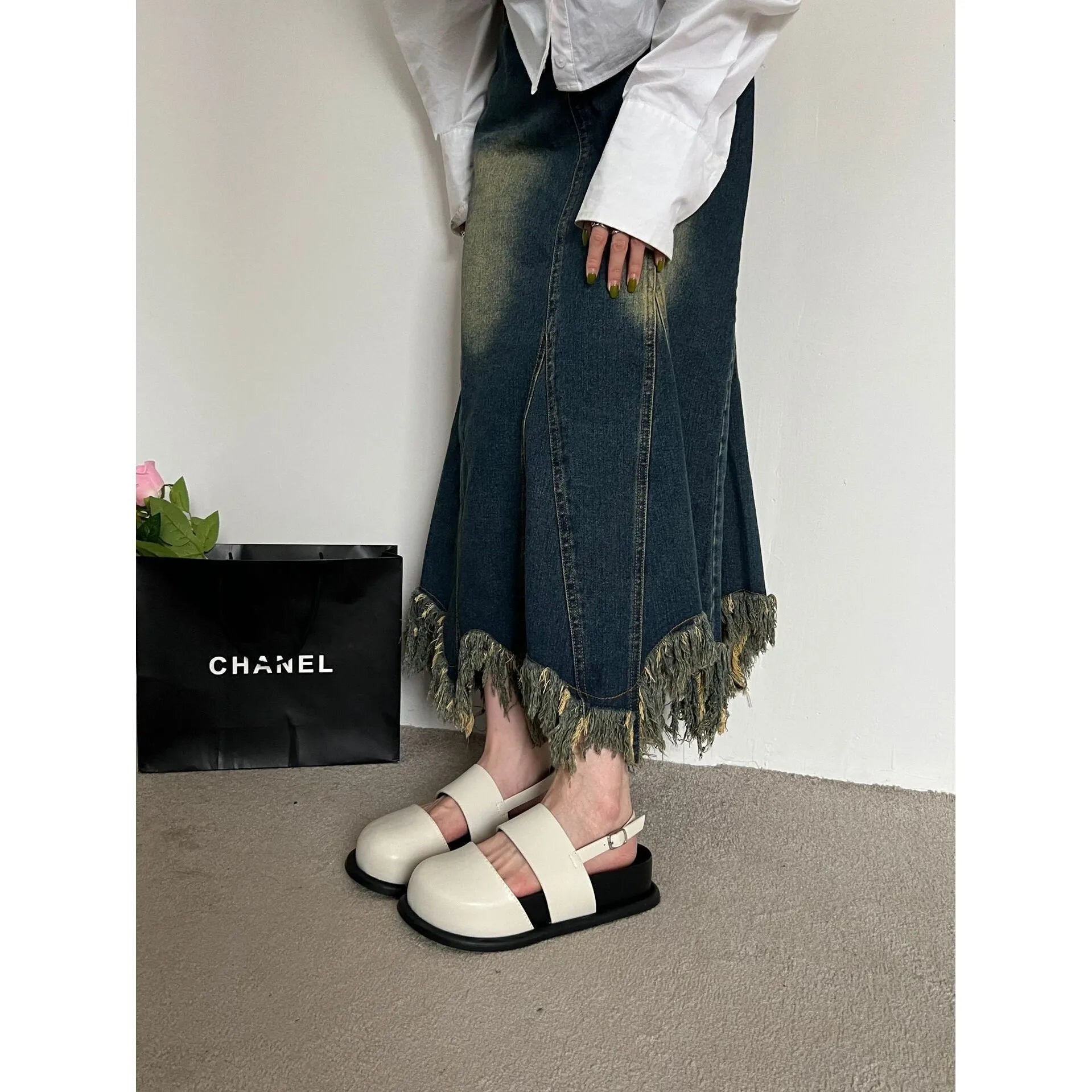 Korean style women's retro sandals with a black microfiber upper and adjustable ankle buckle on a PVC sole.