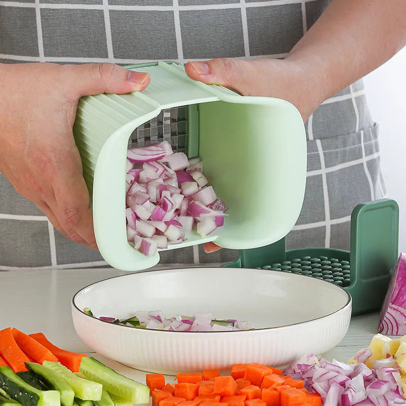 Green manual vegetable chopper with stainless steel blades for onions and potatoes.