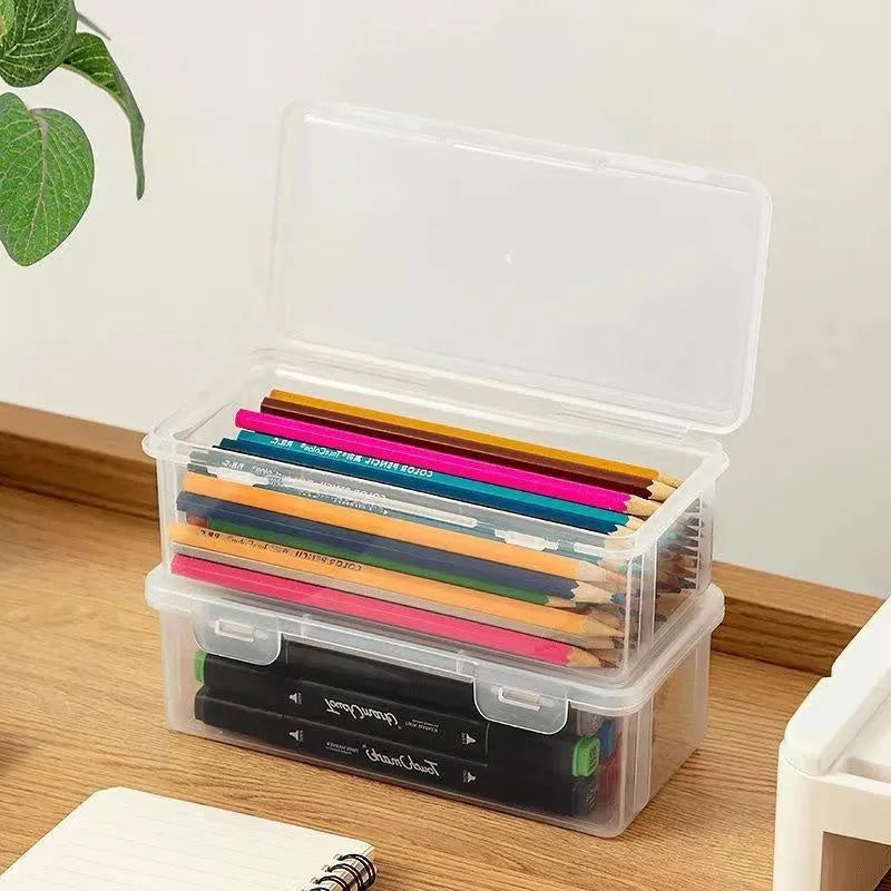 Transparent pencil storage box showing organised stationery including pencils and art supplies
