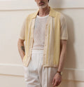 Yellow casual polo shirt with hollow-out design and asymmetric cut, short sleeves, made from Tencel fabric.