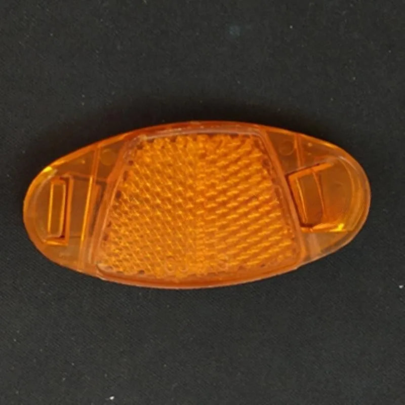 White and yellow plastic bicycle spoke reflectors showing 7.2cm length measurement