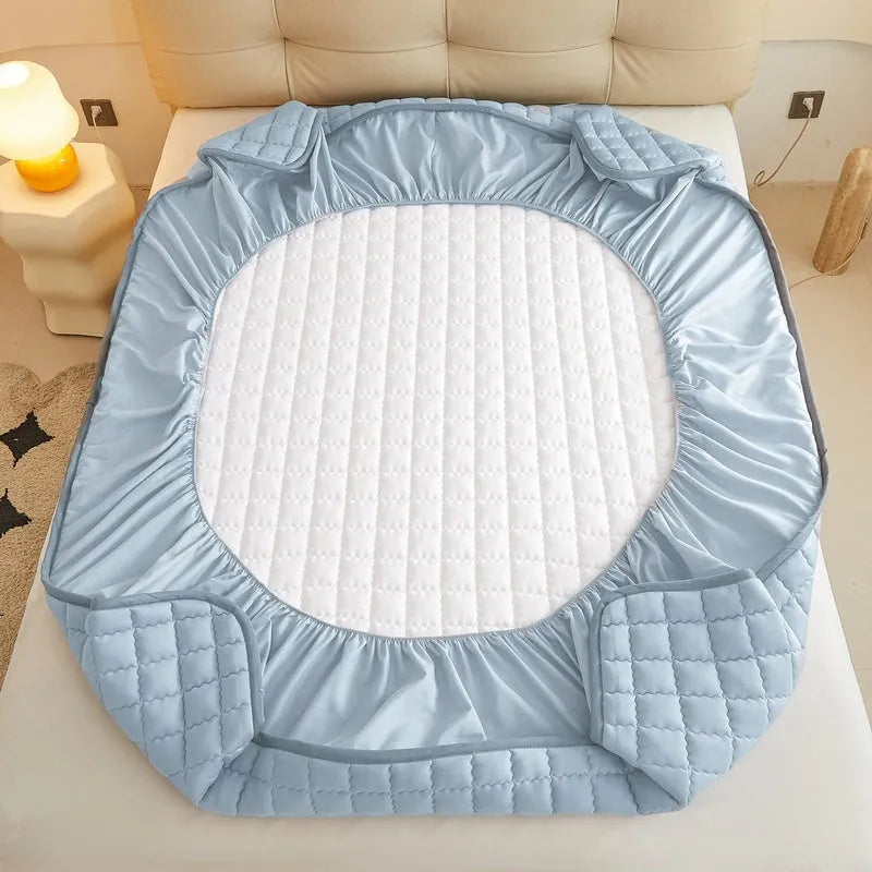 Class A waterproof washed cotton fitted sheet in blue on a bed.