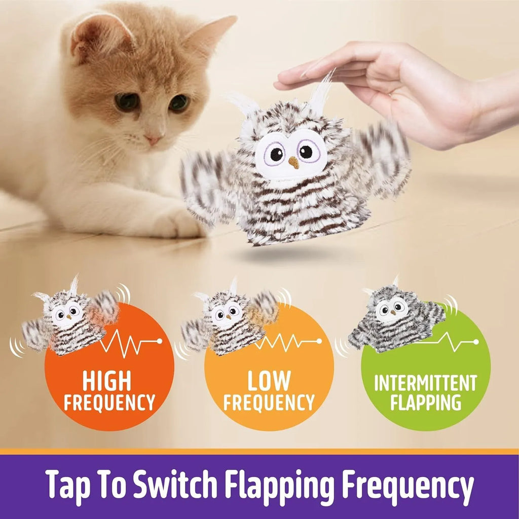 Grey automatic chirping owl cat toy with flapping wings on a flat surface.