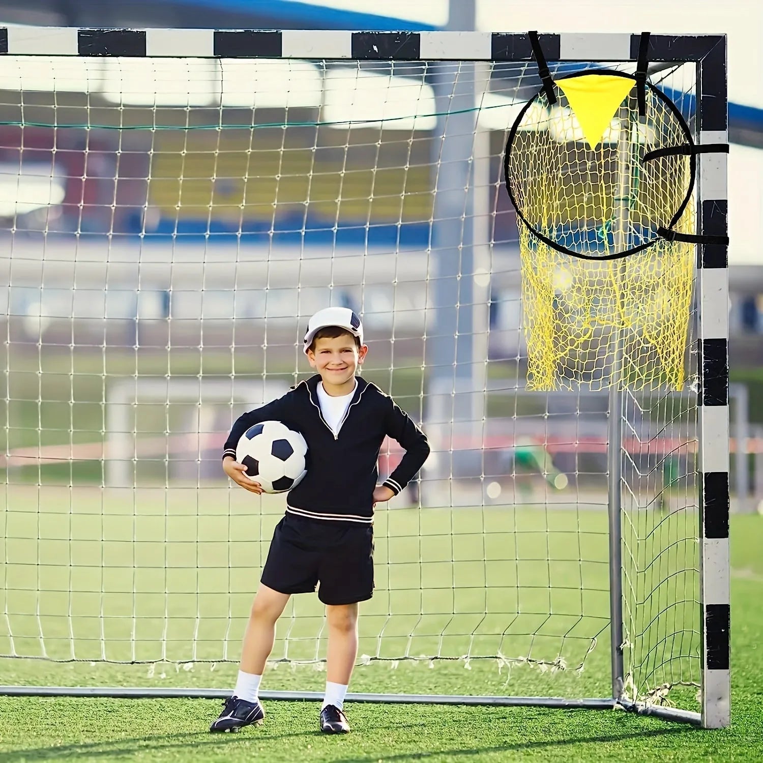 Black portable soccer training goal net with fibreglass poles set up on grass for practice.