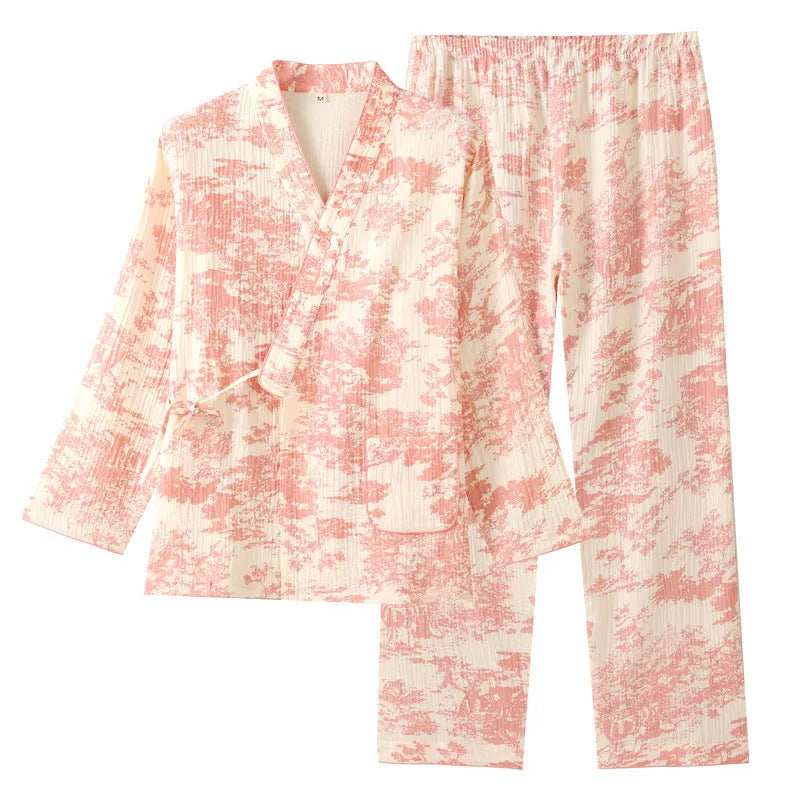 Women's pink cotton gauze lounge suit set with long sleeves and elastic waist trousers laid flat.