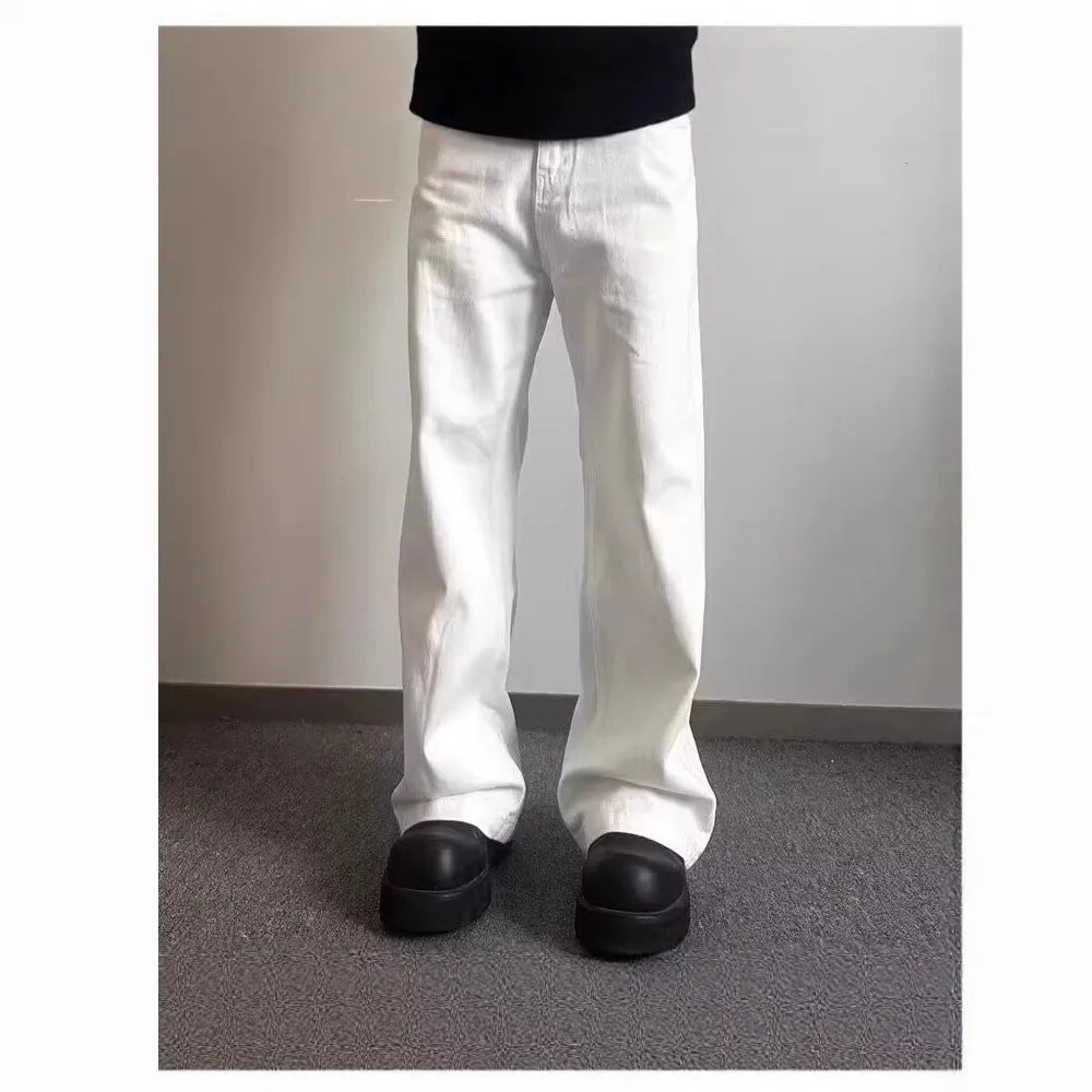 Men's white straight-leg denim jeans with a wide fit and mid-rise waist on a plain background.
