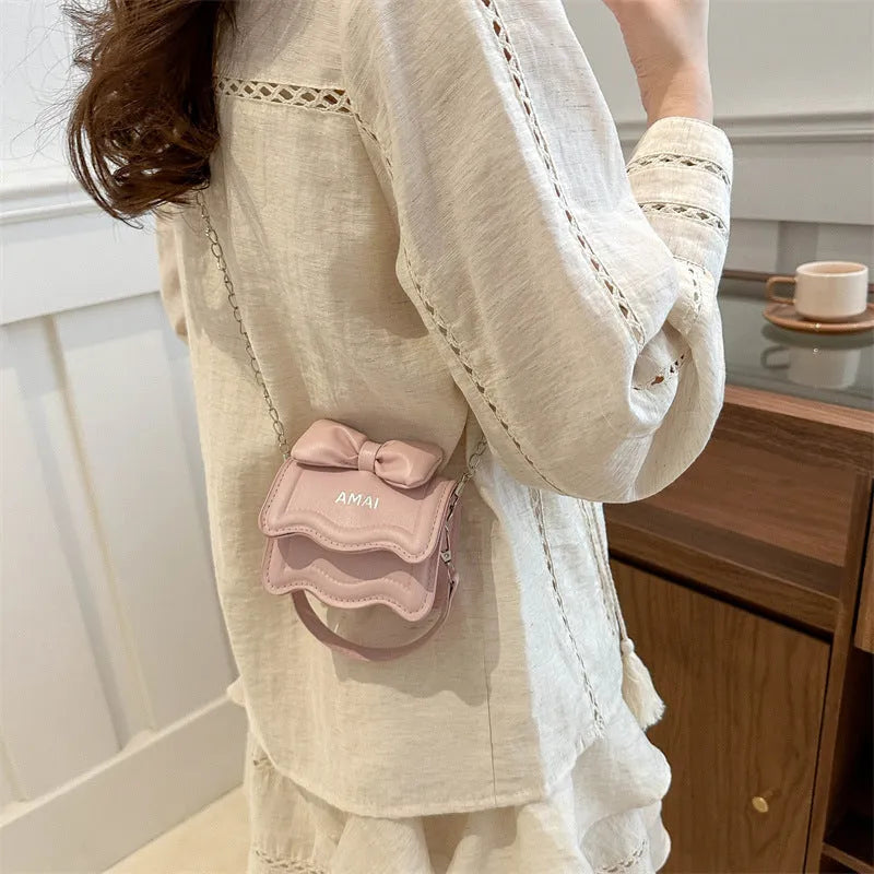 Mini crossbody bag in seven colour options with single shoulder strap and structured PU construction