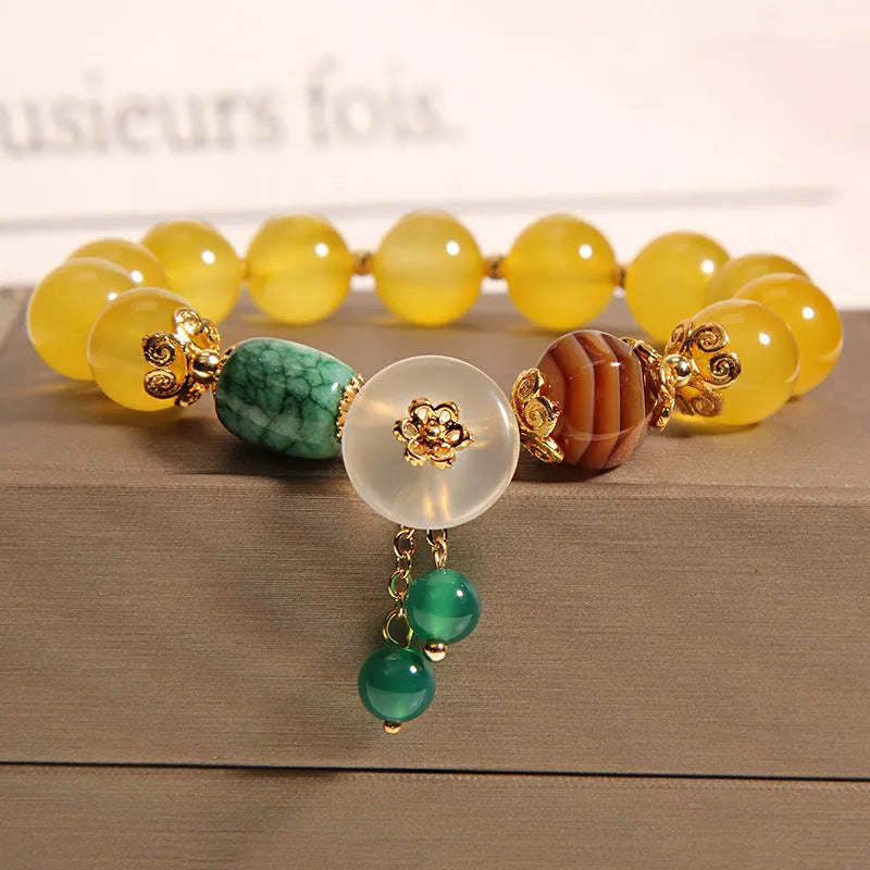 Khaki coloured crystal bracelet for women with an adjustable gold silk cord fastening.