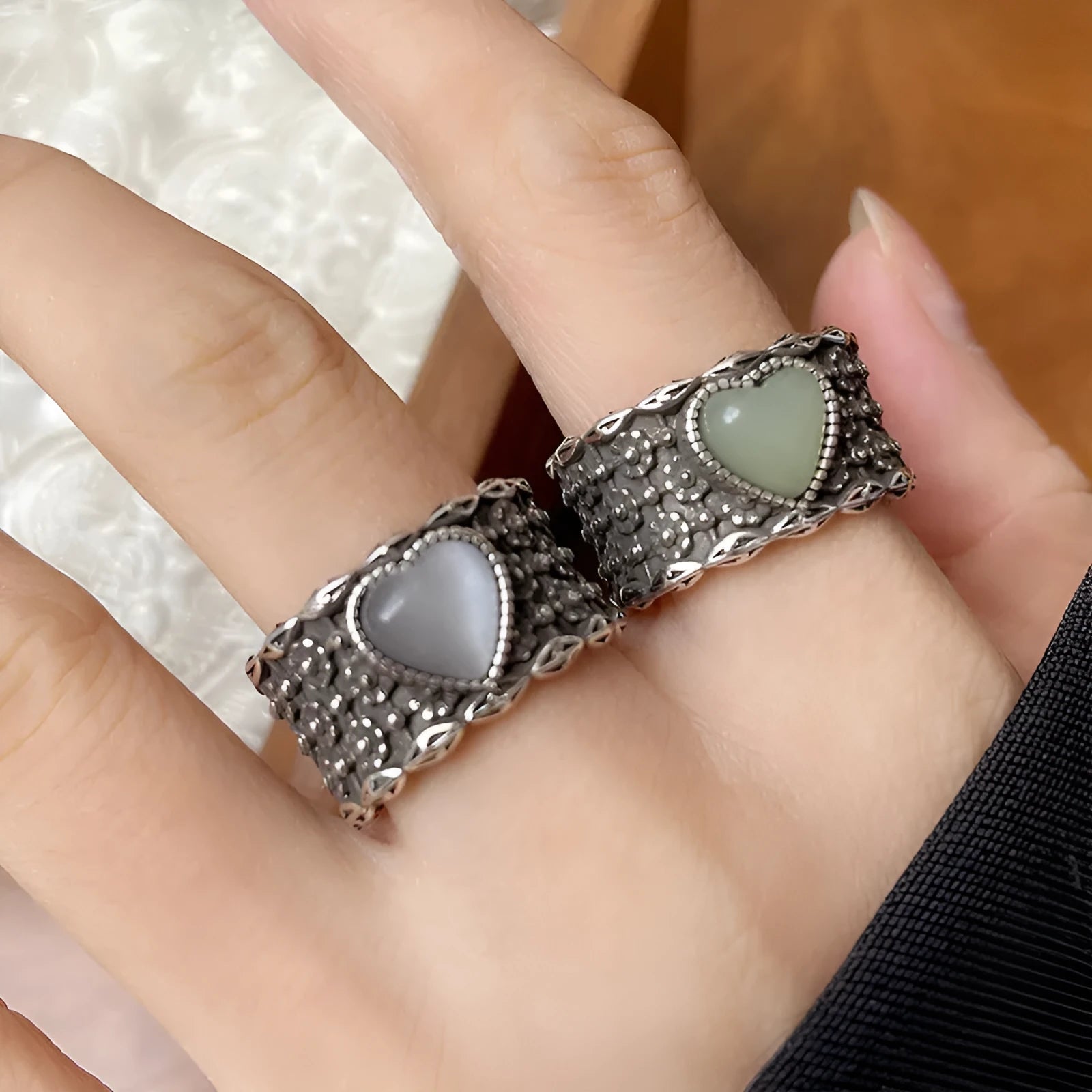 Retro-style adjustable silver heart ring shown in white and green colour options.