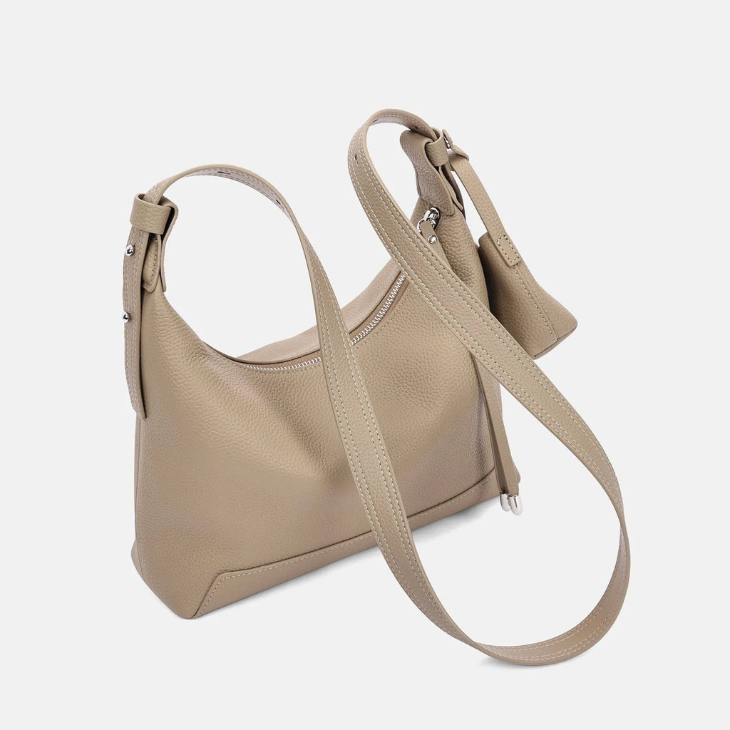Genuine cowhide leather women's shoulder bag in urban simplicity style, shown in soft construction.