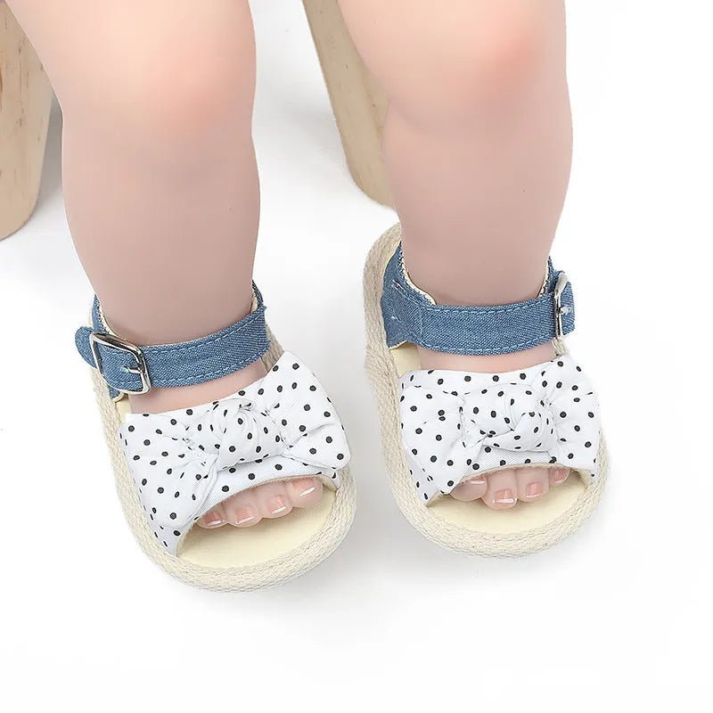 Black and white velcro fastening baby shoes for toddlers, showing low tube height design.