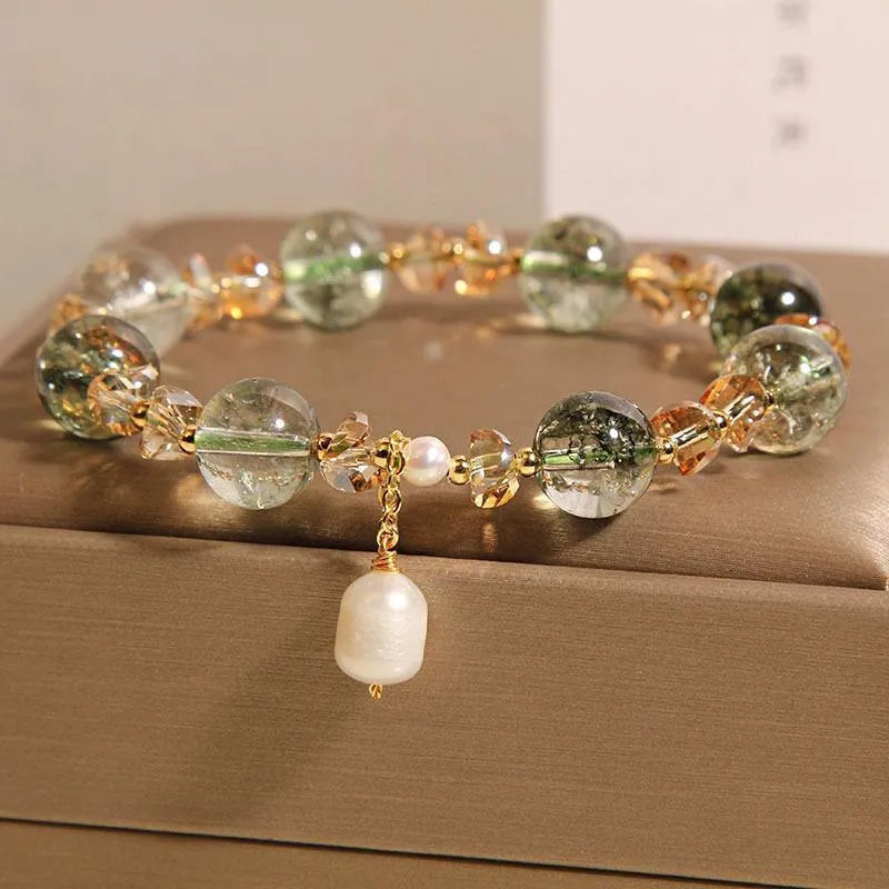 Adjustable green phantom quartz and champagne crystal bead bracelet on a string cord.